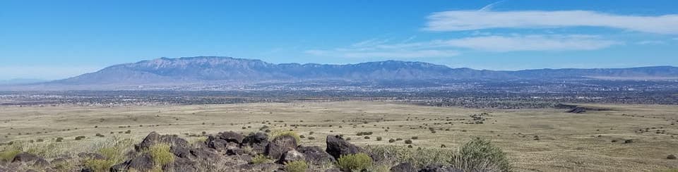 Banner image with a view of the Sandia Mountains